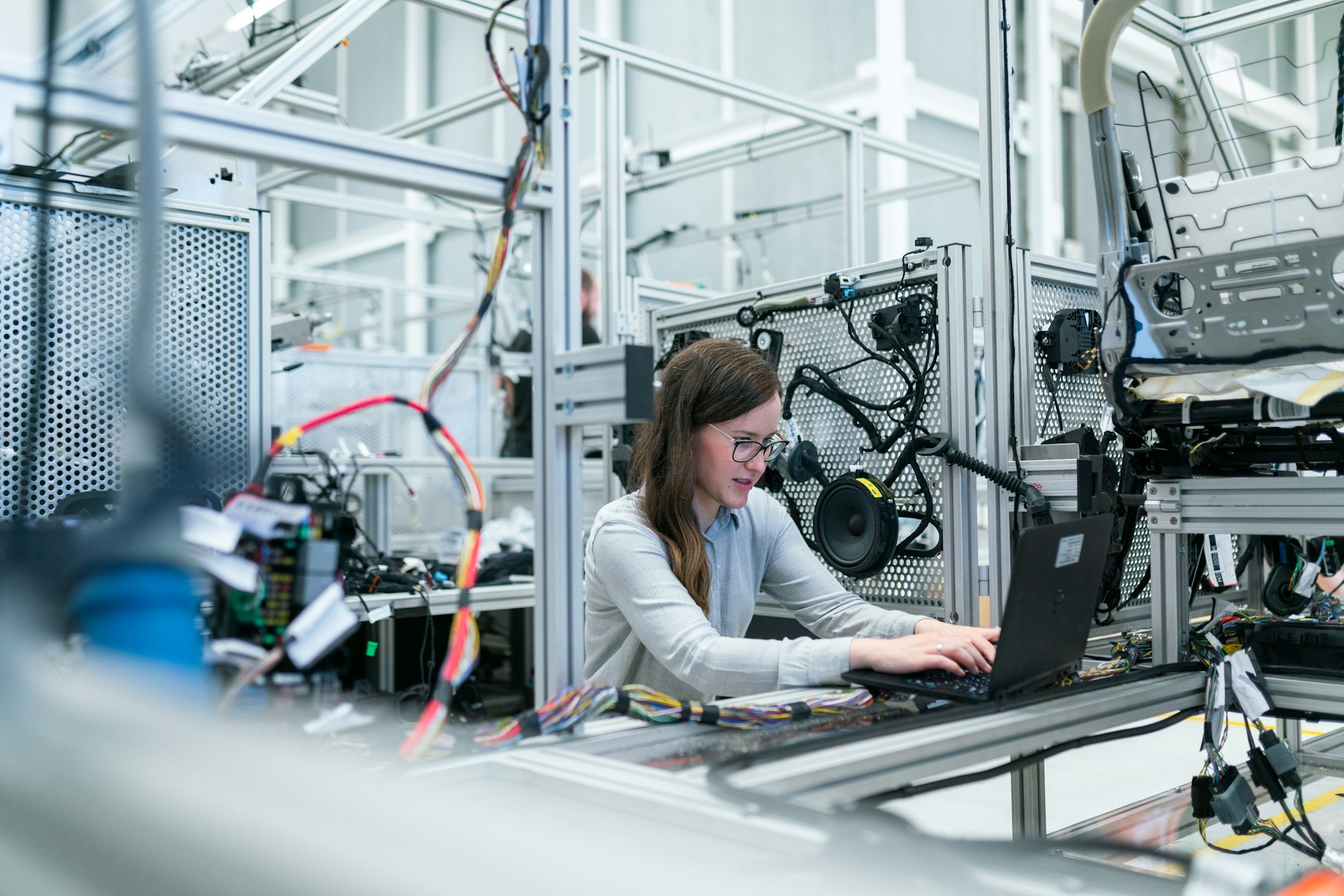 An engineer working on software inside an automotive electronics lab