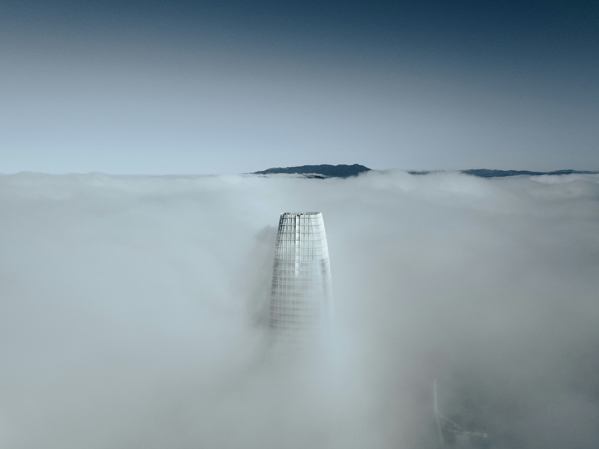 Salesforce Tower emerging through fog over San Francisco
